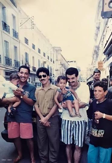 Cheb Hasni and Cheb Nasro with friends on a street